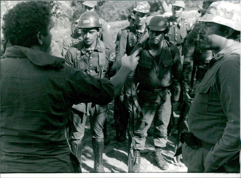 Lt-Col Domingo Monterrosa briefs government troops in El Salvador's eastern region as the conflict between guerilla forces and the government continues. - Vintage Photograph