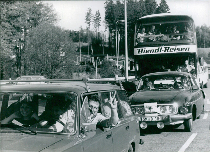 East German refugees cross the border into West Germany, leaving the embassy in Prague and beginning their journey to a new life in the West. - Vintage Photograph