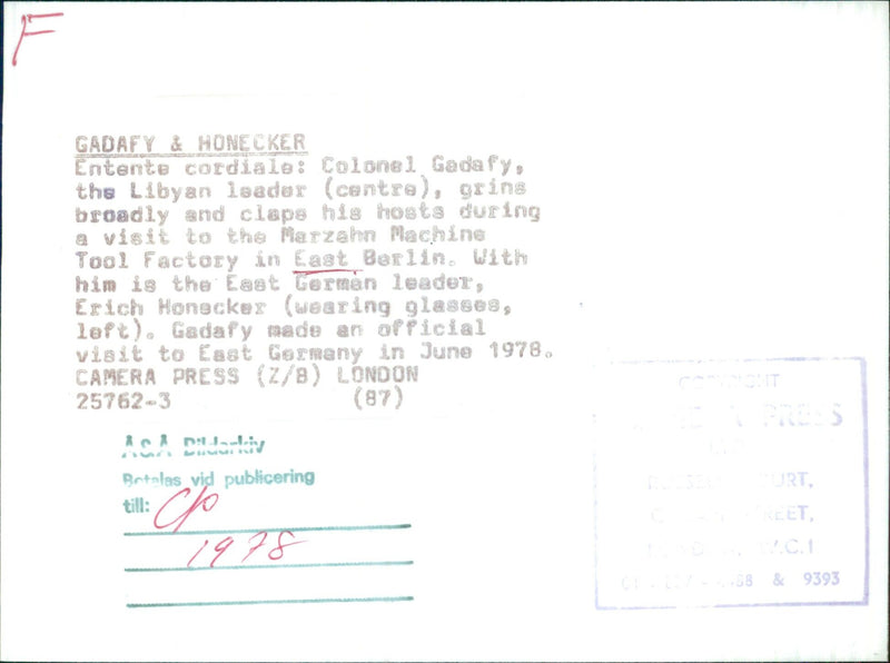 Colonel Gadafy of Libya grins broadly and claps during a visit to the Marzahn Machine Tool Factory in East Berlin, alongside East German leader Erich Honecker in June 1978. - Vintage Photograph