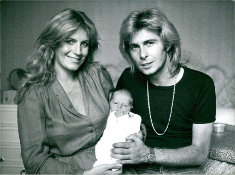 Julie Forsyth and Dominic Grant, members of the singing group Guya and Dolla, pose with their son Luke, born in August 1980. - Vintage Photograph