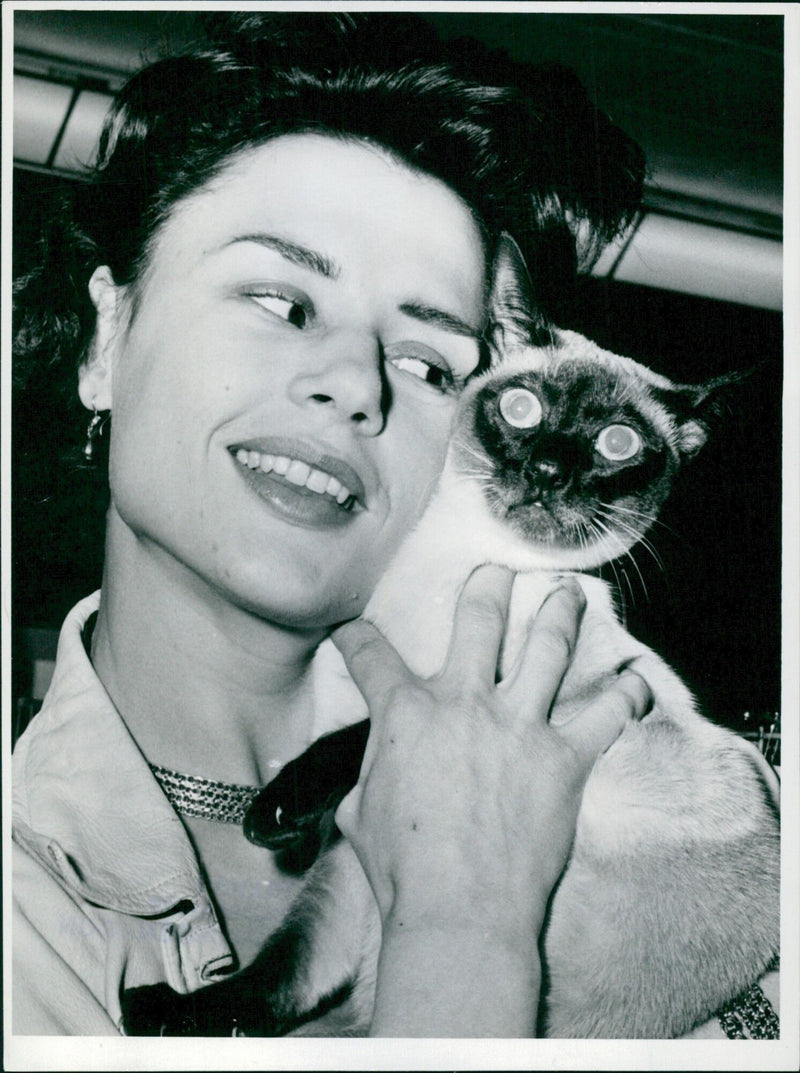 Harriet Andersson poses with her cat Titus at the Cat Exhibition in Kungshallen, Stockholm on February 2, 1957. - Vintage Photograph