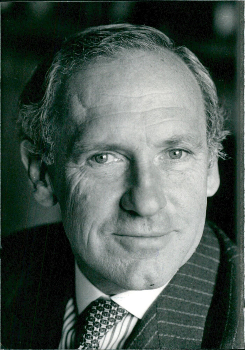 Sir William Heseltine, Private Secretary to the Queen and Keeper of the Queen's Archives, poses for a portrait in London on April 1986. - Vintage Photograph