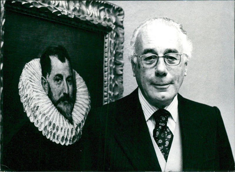 Professor Xavier de Salas, Director of the Prado Museum in Madrid, stands alongside El Greco's painting "A Gentlemen" in London's Royal Academy exhibition of Spanish paintings. - Vintage Photograph