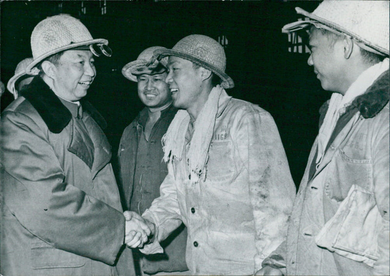 Chinese leader Chairman Hua Kuo-feng meets with steel workers at the Capital Iron and Steel Company in Beijing, China on 1987-11-68. Photo credit: Camera Press. - Vintage Photograph