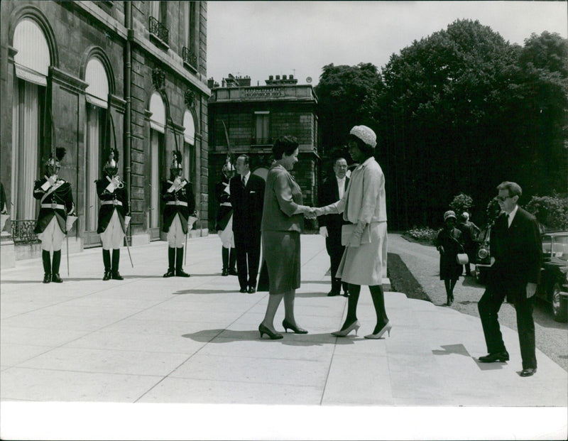 French President Charles de Gaulle and First Lady Yvonne de Gaulle greet Ivorian President Félix Houphouet-Boigny on their state visit to Abidjan, Ivory Coast on June 12, 1951. - Vintage Photograph