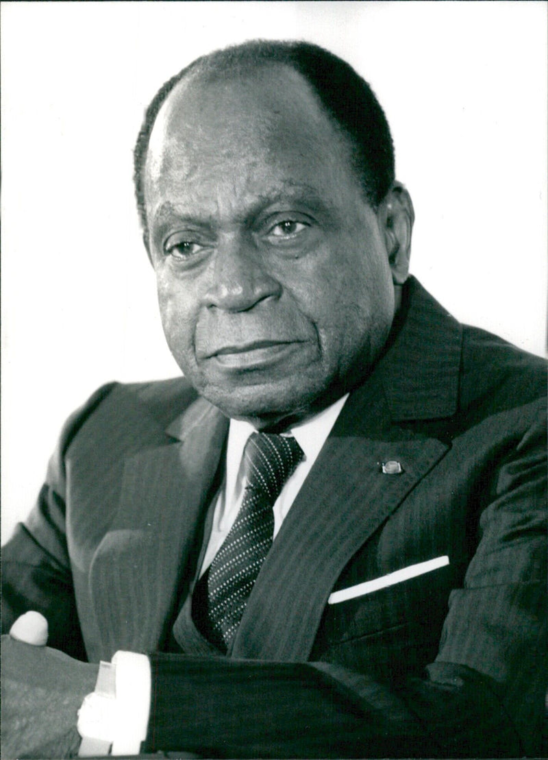 President Felix Houphouet-Boigny of the Ivory Coast Republic poses for a photograph in 1983. - Vintage Photograph