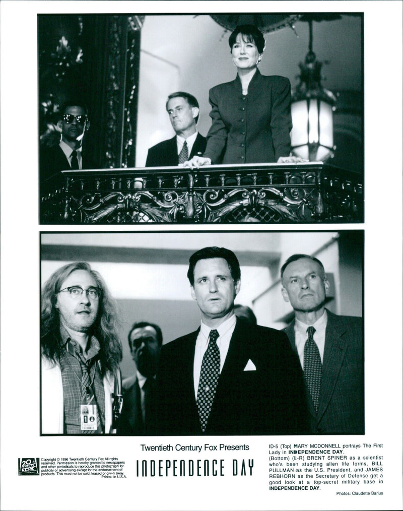 U.S. President Bill Pullman (center) is joined by Mary McDonnell as The First Lady, Brent Spiner as a scientist, and James Rebhorn as the Secretary of Defense in a still from Twentieth Century Fox's 1996 film, Independence Day. - Vintage Photograph