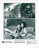 Vivica Fox and Ross Bagley are seen in the aftermath of a devastating attack in Twentieth Century Fox's epic adventure film, "Independence Day". - Vintage Photograph
