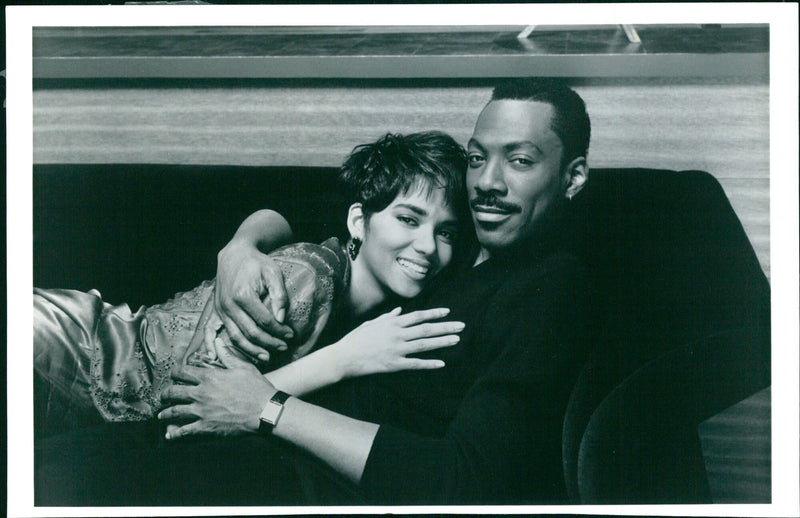 Actor Eddie Murphy and Halle Berry pose for a photo during the AIX8V B.ll. BOOMERANG 2445 92 event. - Vintage Photograph