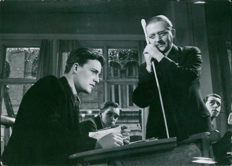 A group of four people from Hels Alf Kjelan & Stig Järrey are seen in a film set in Stockholm, Sweden. The film was produced by HY-104 and is being distributed by Ahlen & Kerlunds Forlag Bildarkivet. - Vintage Photograph