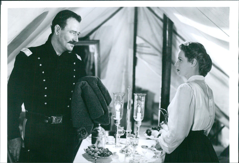 John Wayne and Maureen O'Hara pose on the set of Rio Grande, circa 1950. - Vintage Photograph