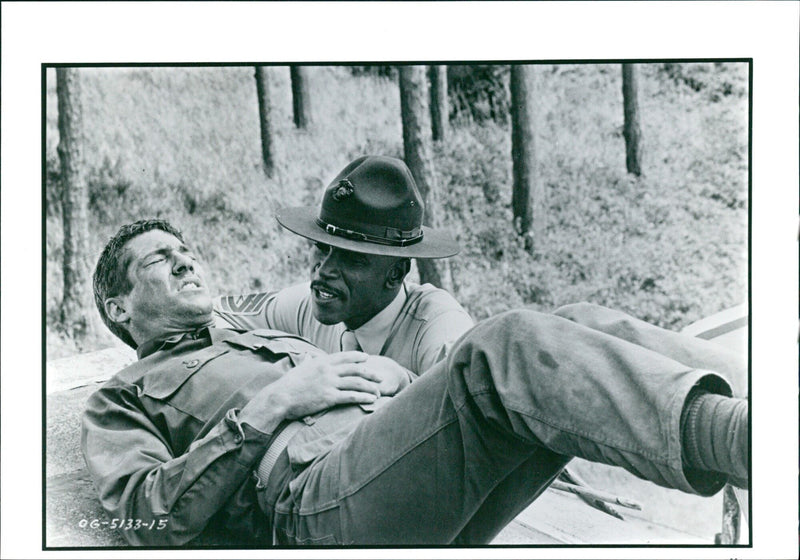 An officer and a gentleman are seen shaking hands in a formal greeting. - Vintage Photograph