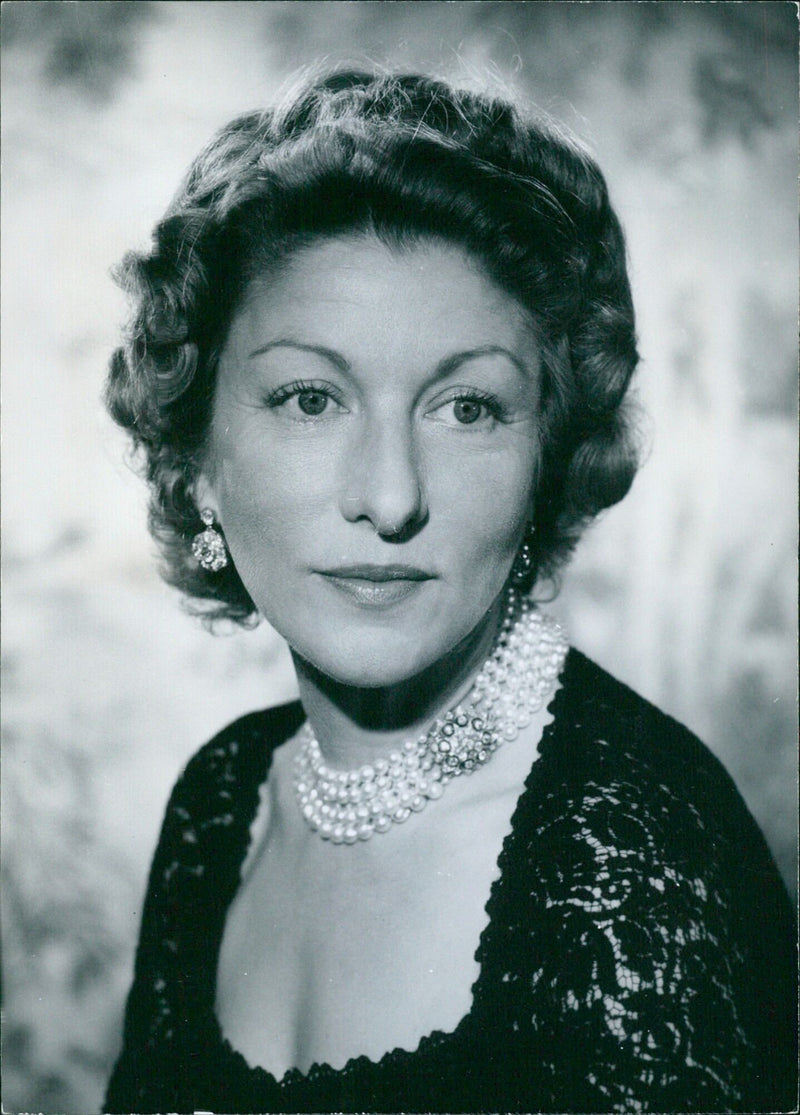 Mrs. Gerald Lascelles, wife of the Hon. Gerald Lascelles, smiles for the camera in a portrait taken on July 10th, 1963 in Stockholm, Sweden. - Vintage Photograph