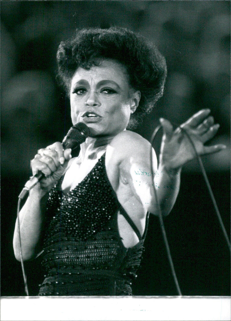 Veteran American singer and entertainer Eartha Kitt performs onstage in 1985. - Vintage Photograph