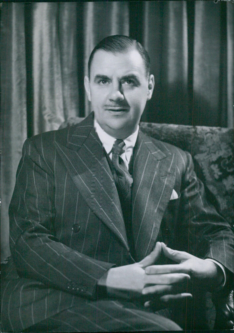 Emile Littler, the celebrated theatrical producer, poses for a portrait study taken by Bassano in London, UK. - Vintage Photograph