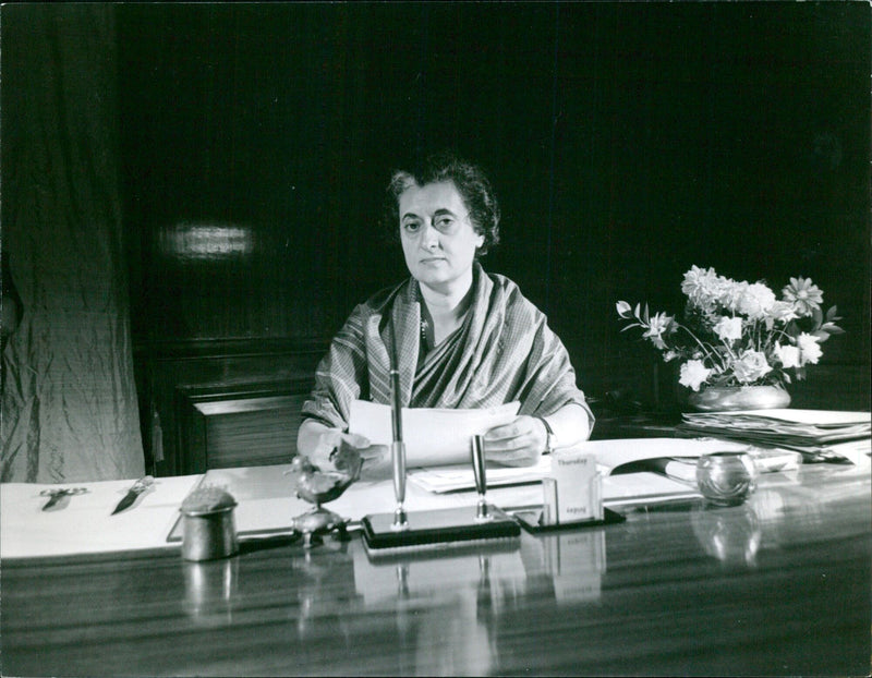 India's Prime Minister, Indira Gandhi, is greeted with a traditional garland of flowers during her visit to Sweden in February 1966. - Vintage Photograph