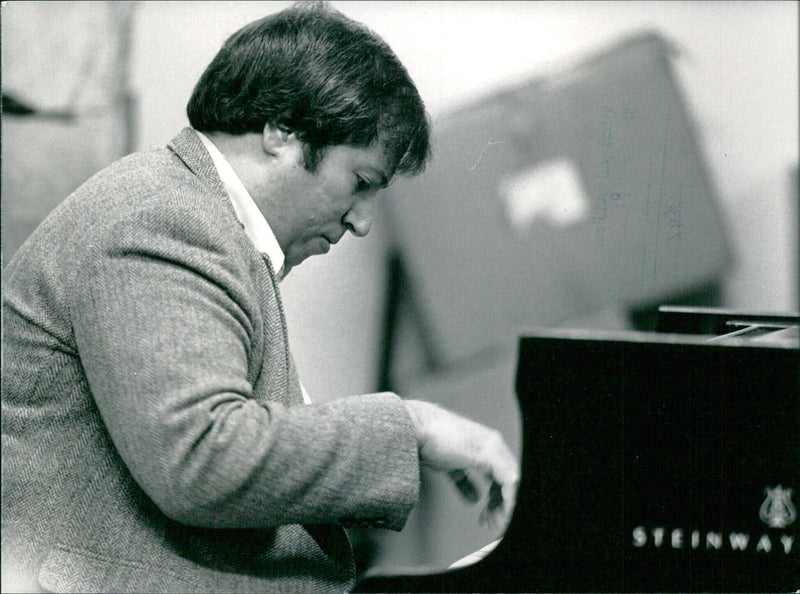 Horacio Gutierrez, Cuban-American concert pianist, rehearsing for a recital at the Queen Elizabeth Hall in London in December 1983. - Vintage Photograph