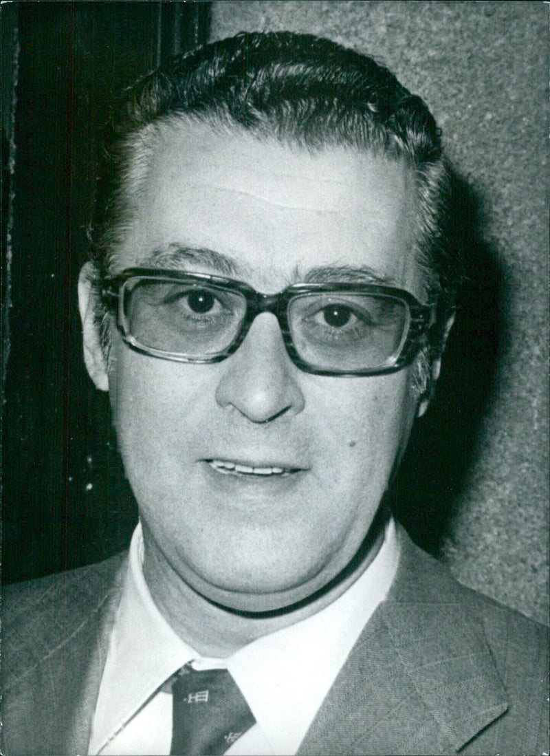 Spanish Minister of Information and Tourism, Andrés Roquera Guajardo of the Christian-Democrat Party, stands in front of a camera during a press event. - Vintage Photograph