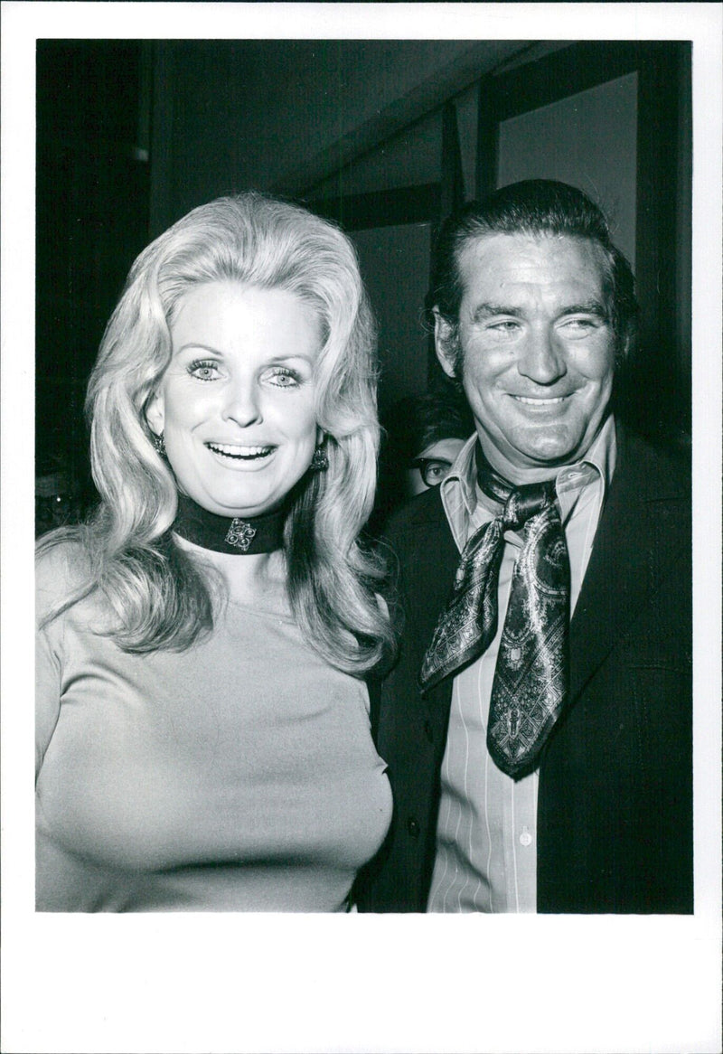 Rod Taylor escorts Pat Crosby, ex-wife of Bing Crosby, to the preview of the movie "Vusa" at the Directors Guild Theatre in Los Angeles. - Vintage Photograph