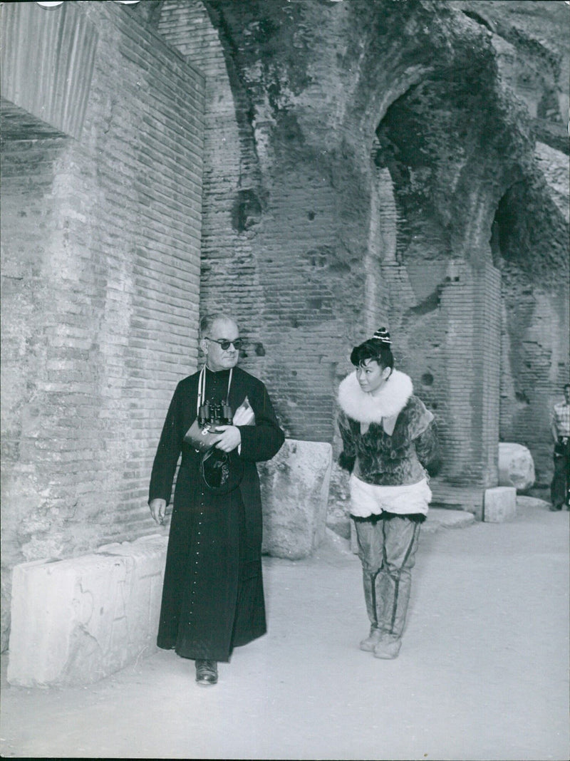 A woman stands in the doorway of a building in Rome, Italy. - Vintage Photograph