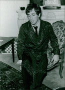 On October 5, 1963, a fashion show was held at Paris-M Marie Claire in Rue Pierre Charron in Paris, France. Models wearing the latest fashion styles from the Marie Claire magazine walked the runway while attendees looked on. - Vintage Photograph