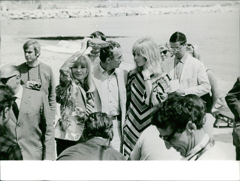 Director Michelangelo Antonioni and his wife (left) and actress Vanessa Redgrave (right) pose for a photo at the 1967 Cannes Film Festival, where Antonioni's film "Blow-Up" made a splash. - Vintage Photograph