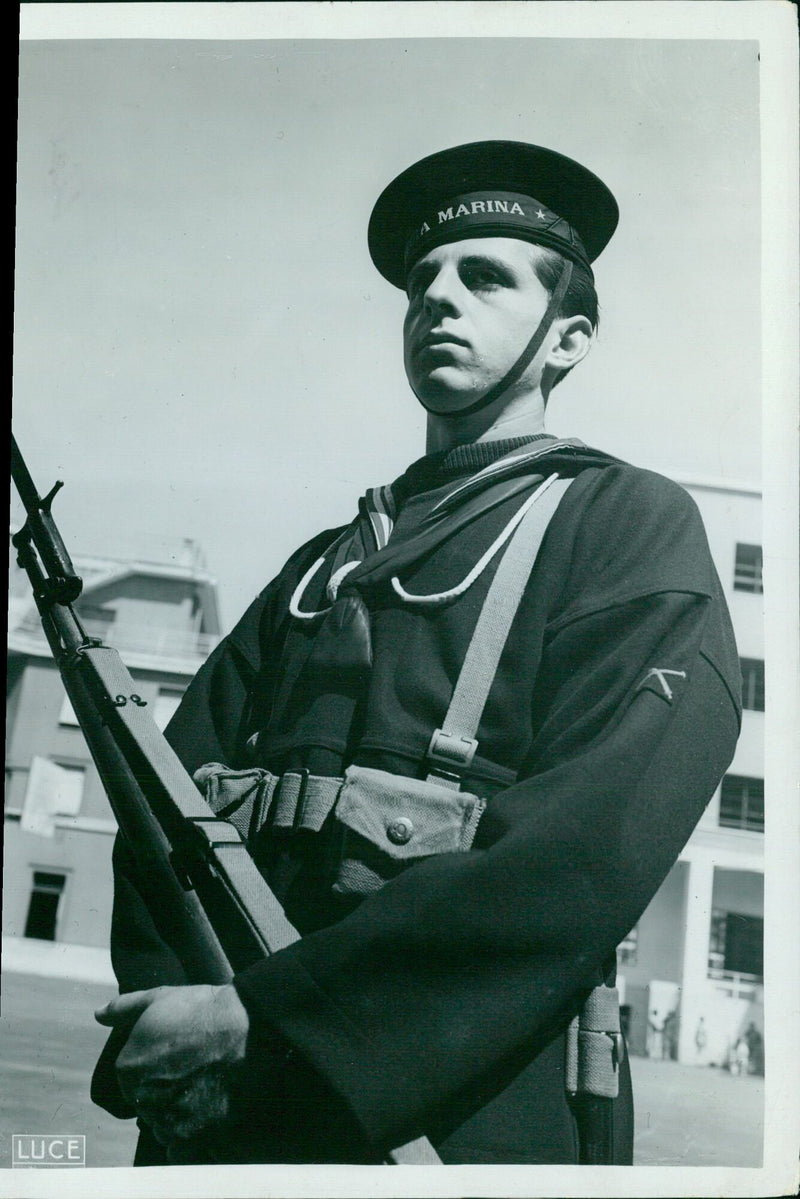 Iranian soldiers in traditional uniforms, standing in formation with their arms raised in salute, in 1940. - Vintage Photograph