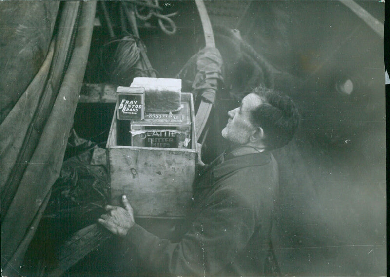 Cook Dennis Clark, aged 57, is seen on the deck of the Star of Isles, providing provisions to the lifeboats after the vessel was attacked. The photo was taken on 1998-07-31 and provided by The Daily Mirror Illustrations Bureau. - Vintage Photograph