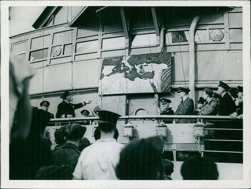 Rear Admiral Sir Harold Burrough explains the forthcoming Allied operations to officers and men onboard his flagship en route for Gibraltar during the largest seaborne expedition in history. - Vintage Photograph