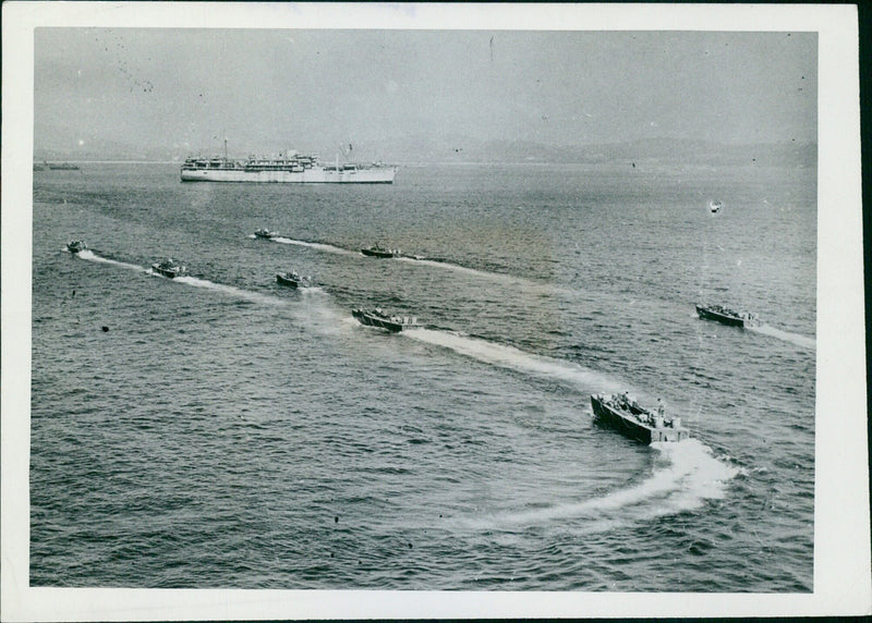 Allied troops embark on a ship-to-shore shuttle service to a beach in Southern France as part of the initial Allied landings on August 15, 1944. - Vintage Photograph