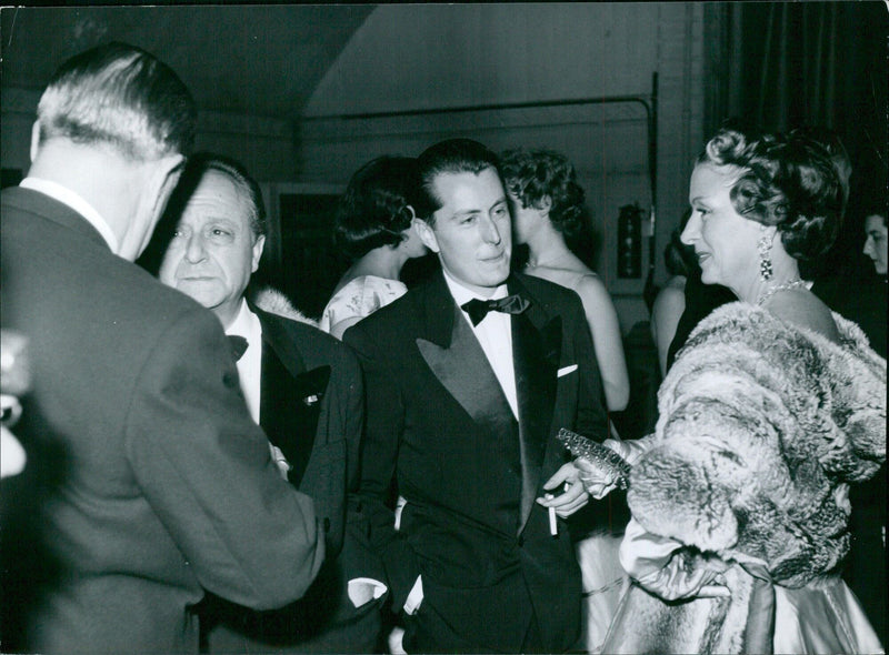 Madame Derval speaks with painter Bernard Buffet during the "Bal Renoir" event. - Vintage Photograph