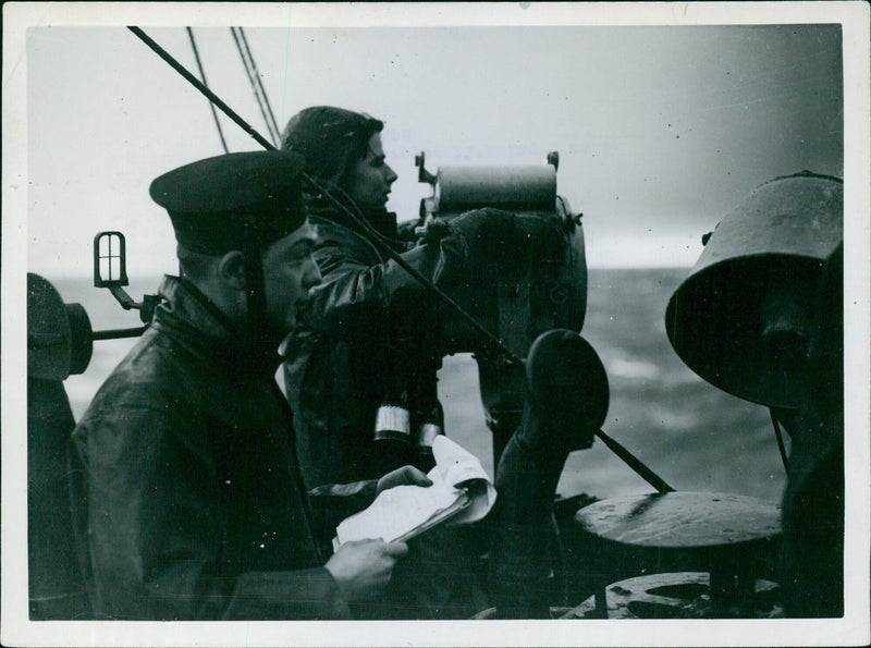 British navy warships take over a convoy from the US battle fleet in the Atlantic Ocean, exchanging messages and pleasantries before the US vessels turn away. - Vintage Photograph