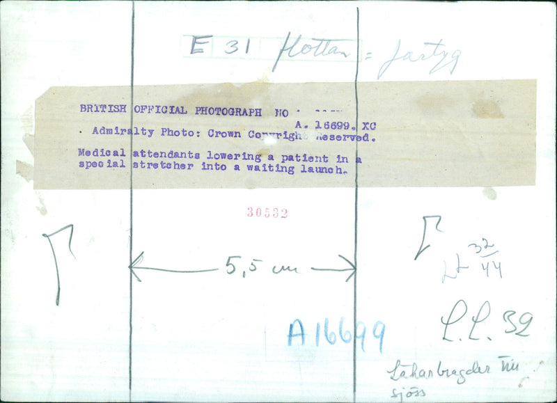 Medical personnel are seen carefully lowering a patient in a special stretcher into a waiting launch at the MELENA E 31 Hottan ship, on April 22, 1939. - Vintage Photograph