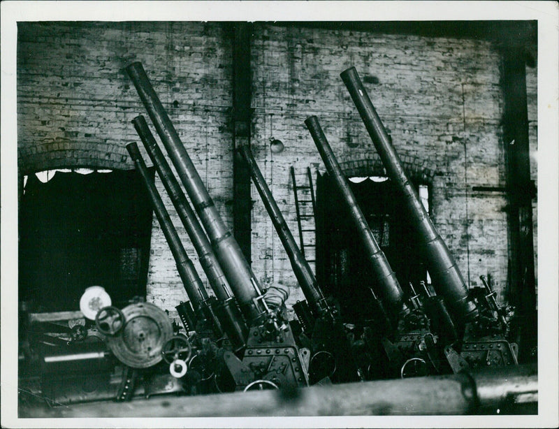 Merchant navy crews train to use defensive armament to ward off submarine attacks while at sea. - Vintage Photograph