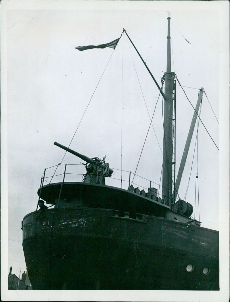 Merchant navy personnel receive training in the efficient use of arms and ammunition in 1940, equipping their ships with defensive armament to protect against U-boat attacks. - Vintage Photograph