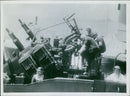 British fleet and planes protect a convoy in the Mediterranean from a two-day attack by aircraft, E-Boete, and submarines, resulting in the loss of the destroyer Fearless. Pom-pom guns are seen in action during the engagement. - Vintage Photograph