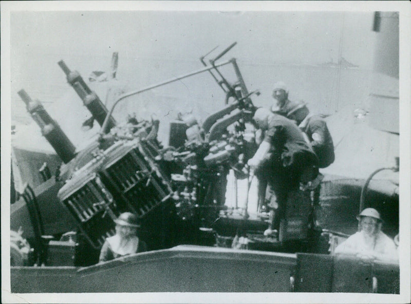 British fleet and planes protect a convoy in the Mediterranean from a two-day attack by aircraft, E-Boete, and submarines, resulting in the loss of the destroyer Fearless. Pom-pom guns are seen in action during the engagement. - Vintage Photograph