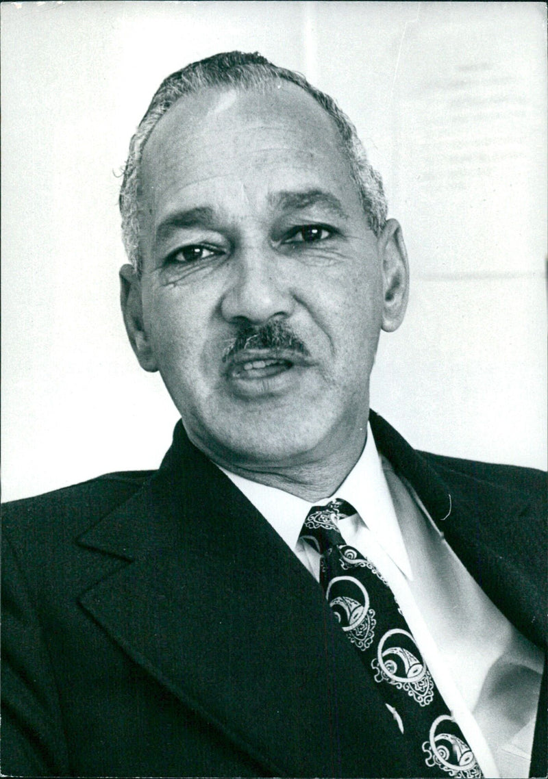 Dr. Richard Van der Ross, Rector of the University of Western Cape, is pictured at his desk in 1975. - Vintage Photograph