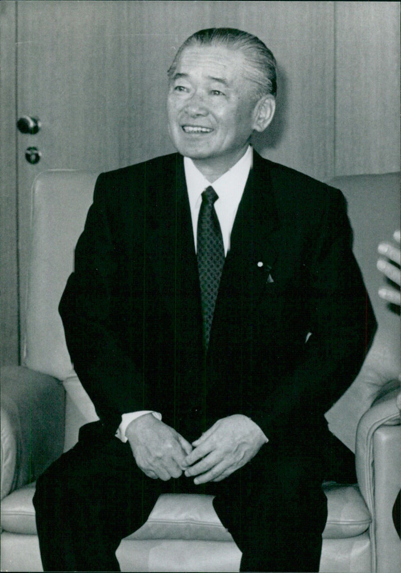 Japanese Prime Minister Noboru Takeshita poses for a photograph in 1988. - Vintage Photograph