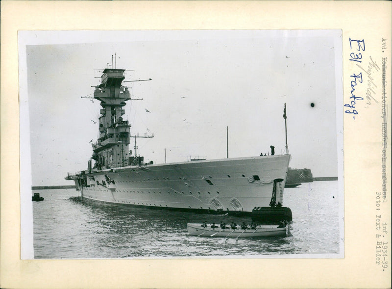 The aircraft carrier "Hermes" departs Plymouth, England to journey to China, with Commander E. Fullerton and the crew inspecting the vessel before departure. - Vintage Photograph