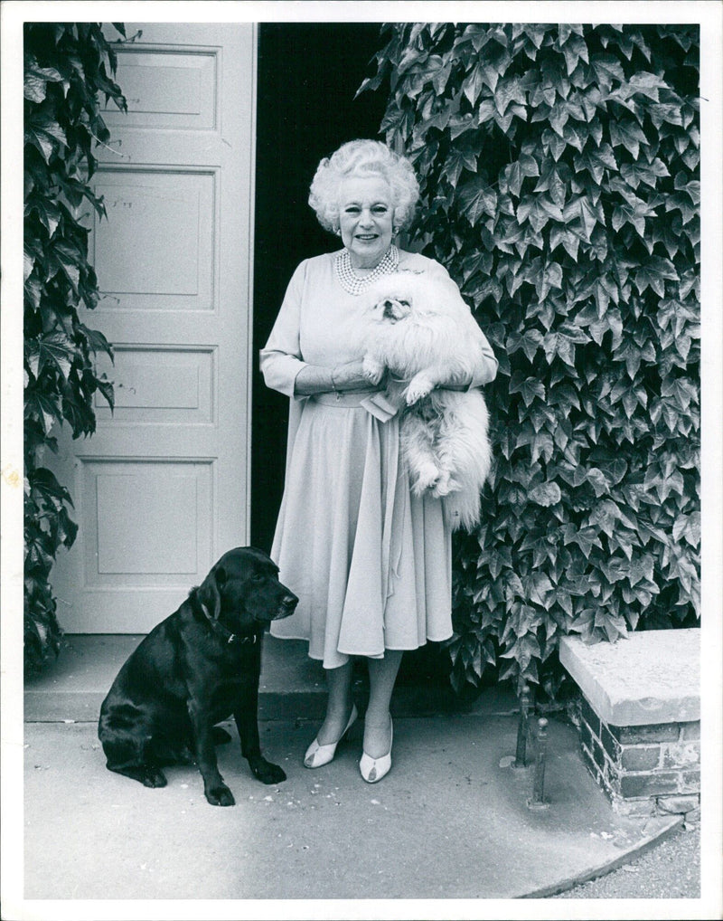 Barbara Cartland, the celebrated British author, is seen here at her home in London on 3 Whinfell Close. - Vintage Photograph