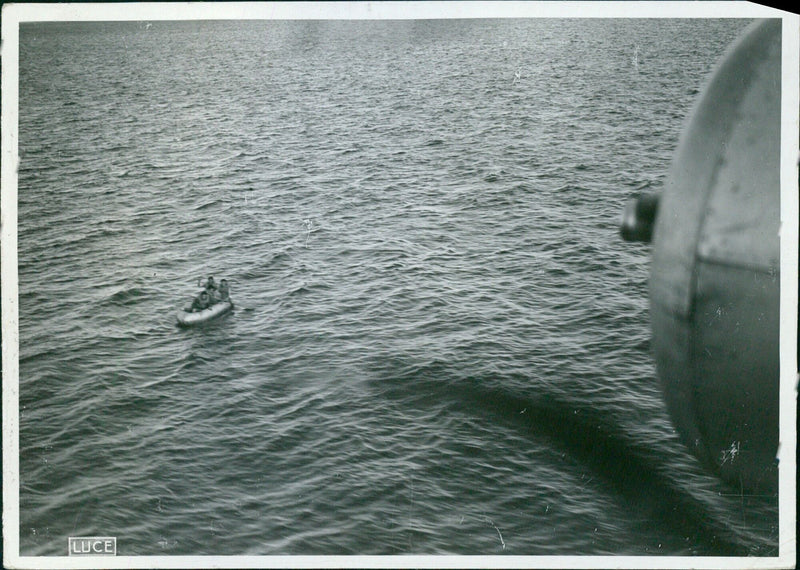 British aircrew are rescued by a rubber boat after their plane is damaged in a skirmish with Italian fighter jets. - Vintage Photograph