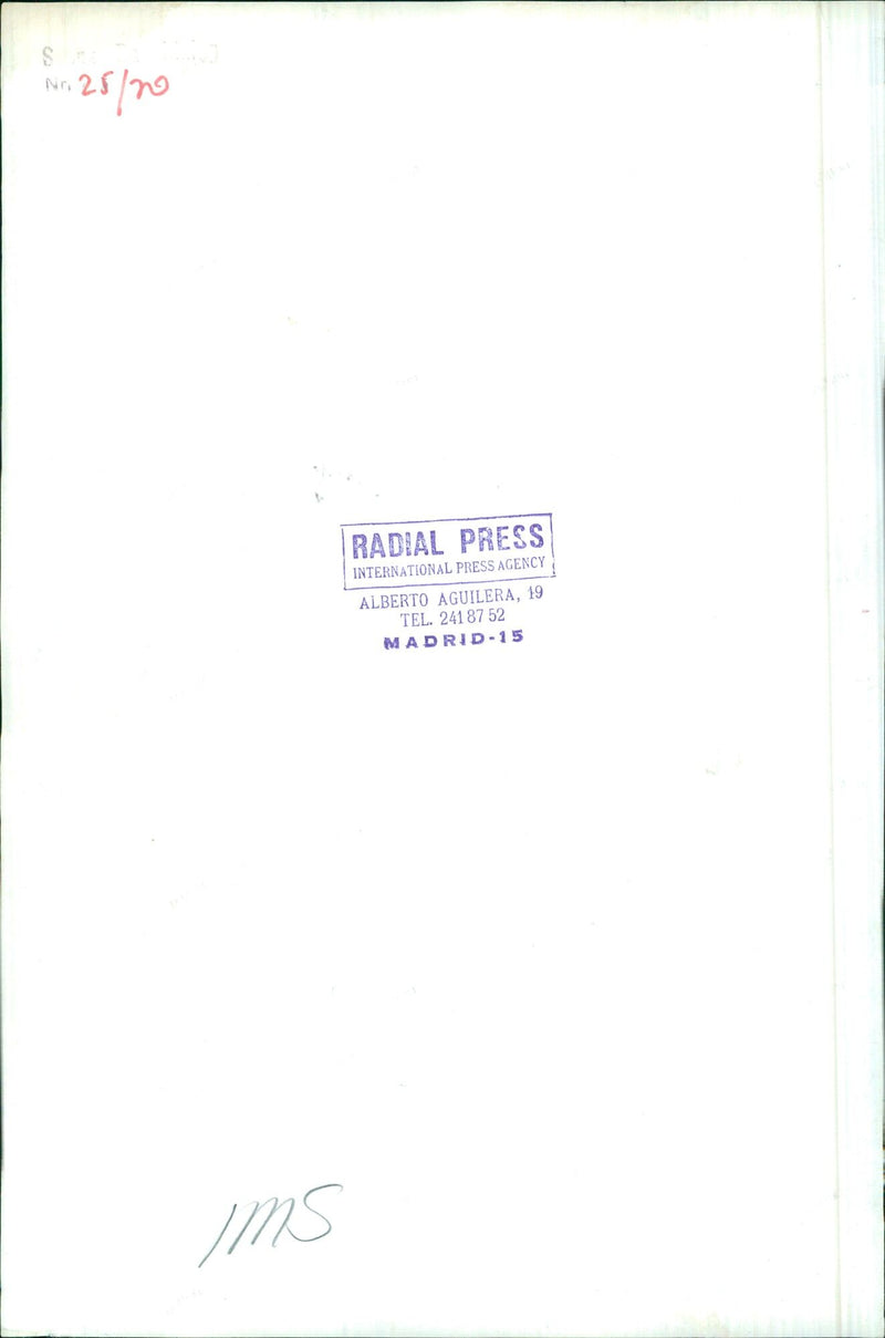 On April 26, 2021, a press photographer stands next to a number 25 IMS Radial Press International Press Agency sign in Madrid, Spain. - Vintage Photograph