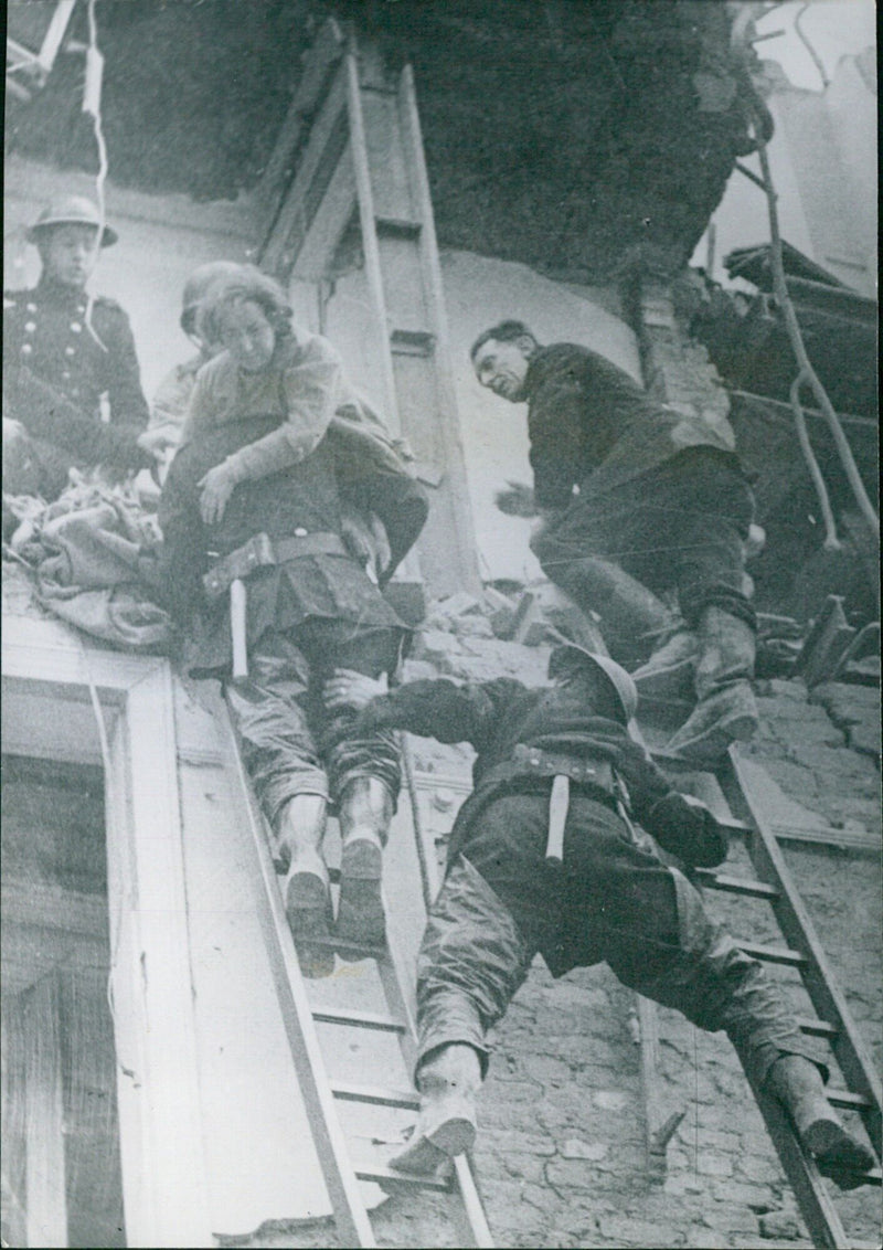 Firefighters attend to the victims of a robotic bombing raid in London on July 27, 1944, during World War II. - Vintage Photograph