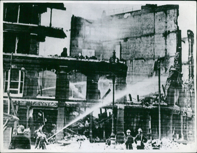 Firefighters in London struggle to contain the spreading flames from bombed buildings in the face of a powerful autumn storm. - Vintage Photograph