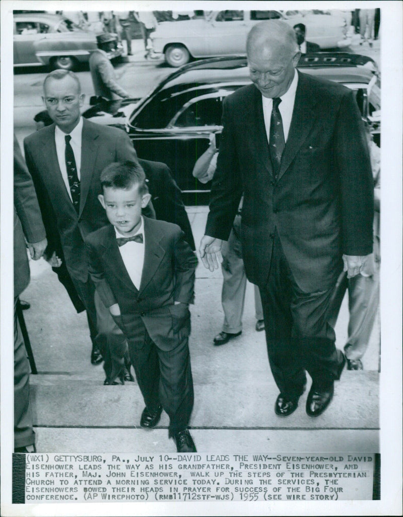 President Dwight D. Eisenhower walks with his son, Major John Eisenhower, and grandson, seven-year-old David Eisenhower, up the steps of the Presbyterian Church in Gettysburg, Pennsylvania to attend a morning service in 1955. - Vintage Photograph