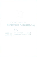 A group of people gather in front of a building in Paris, France on an autumn day. - Vintage Photograph