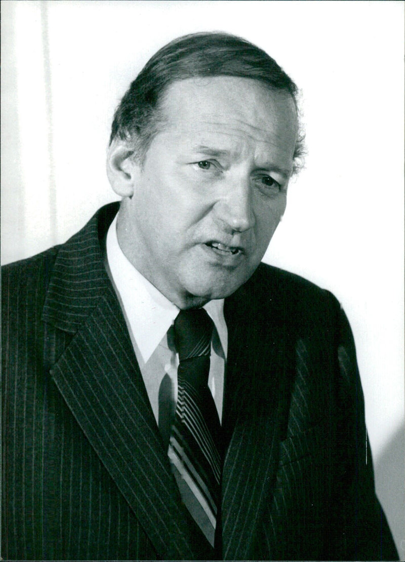 Canadian politician Gerald Regan, Minister of Labour and former Premier of Nova Scotia, stands alongside a colleague during a press conference in 1980. - Vintage Photograph