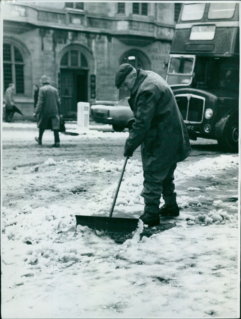 Oxford Council workman clears away snow and slush from the pavement. - Vintage Photograph