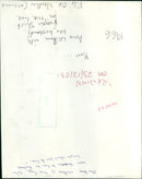 Anne Welham attempts to free her husband's frozen shirt from the line. - Vintage Photograph